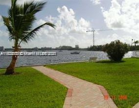 2910 Point E Dr Unit M610, Aventura, FL 33160 - view of green lawn featuring a water view