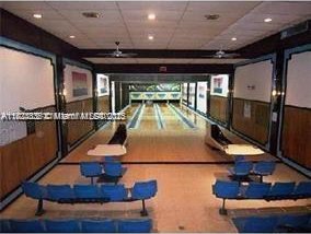 2910 Point E Dr Unit M610, Aventura, FL 33160 - recreation room with bowling, a drop ceiling, wooden walls, and recessed lighting