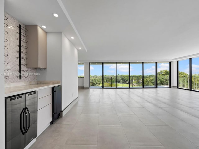 700 Coral Way Unit 5, Coral Gables, FL 33134 - unfurnished living room with floor to ceiling windows, recessed lighting, and light tile patterned floors