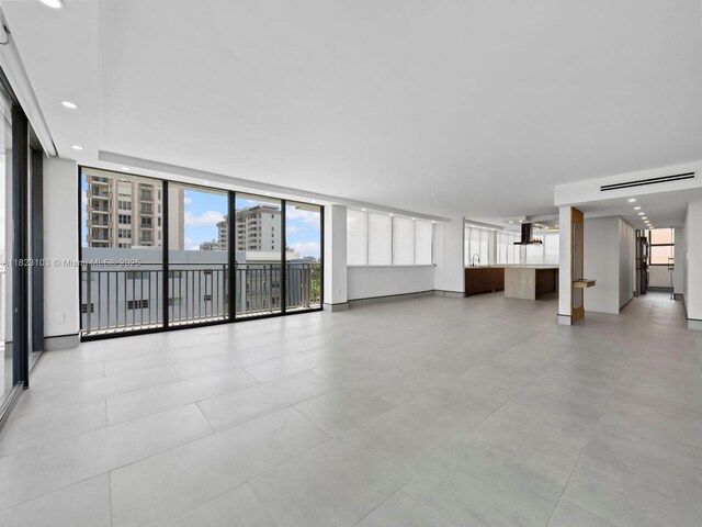 700 Coral Way Unit 5, Coral Gables, FL 33134 - unfurnished living room featuring recessed lighting and floor to ceiling windows