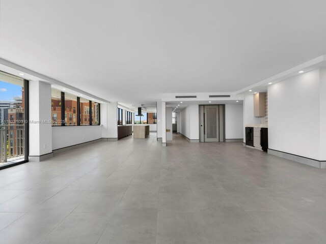 700 Coral Way Unit 5, Coral Gables, FL 33134 - unfurnished living room with recessed lighting and baseboards