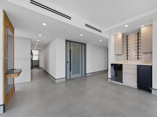 700 Coral Way Unit 5, Coral Gables, FL 33134 - indoor wet bar featuring recessed lighting, refrigerator, backsplash, and beverage cooler