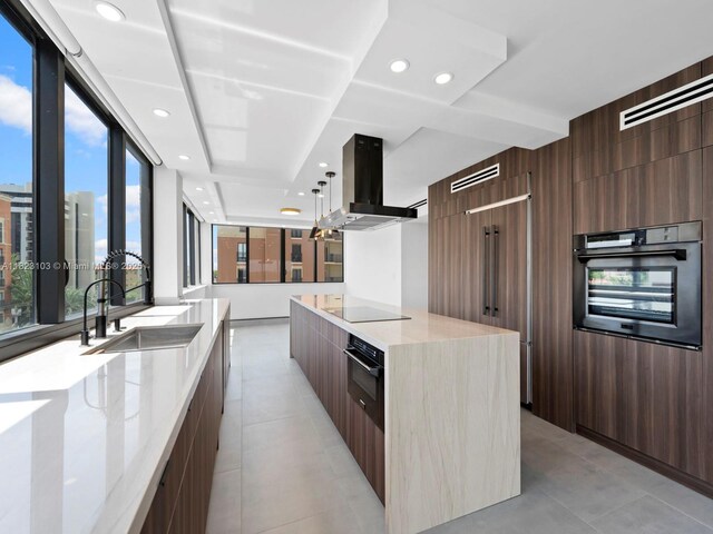 700 Coral Way Unit 5, Coral Gables, FL 33134 - kitchen with modern cabinets, black appliances, exhaust hood, a large island, and recessed lighting