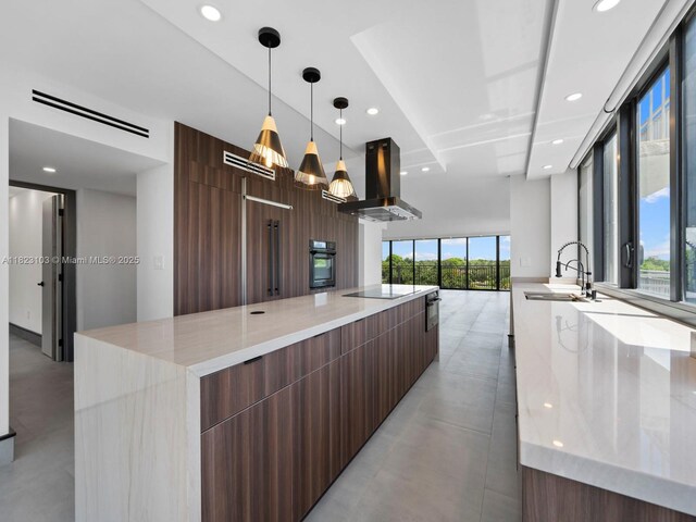 700 Coral Way Unit 5, Coral Gables, FL 33134 - kitchen featuring modern cabinets, island range hood, black appliances, a spacious island, and finished concrete flooring