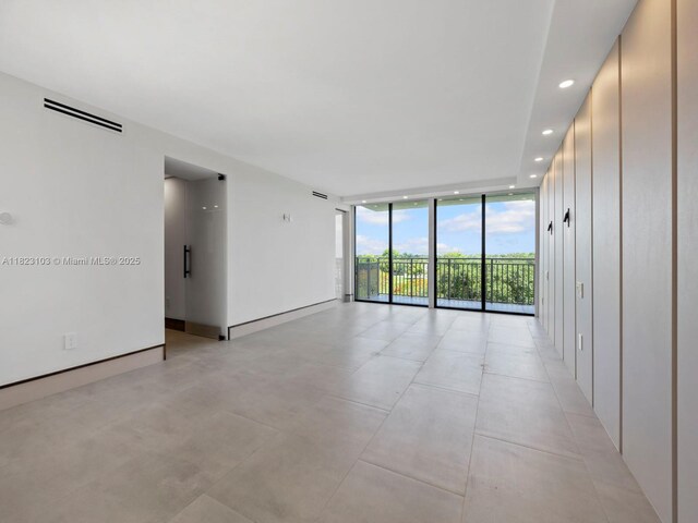700 Coral Way Unit 5, Coral Gables, FL 33134 - unfurnished room with floor to ceiling windows and recessed lighting
