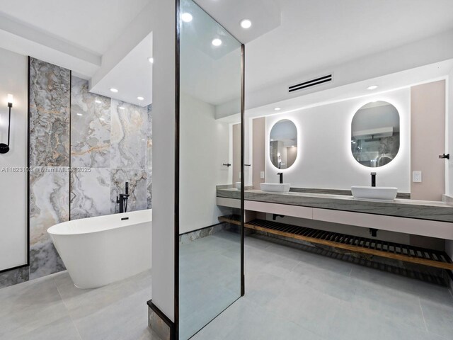 700 Coral Way Unit 5, Coral Gables, FL 33134 - full bath with a freestanding bath, double vanity, recessed lighting, tile patterned floors, and tile walls