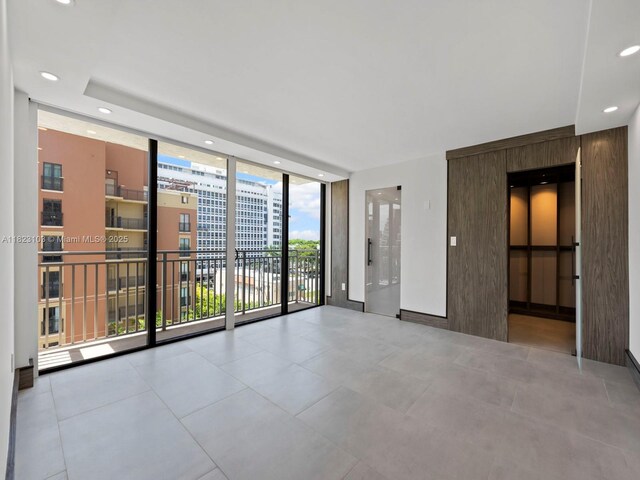 700 Coral Way Unit 5, Coral Gables, FL 33134 - empty room featuring expansive windows, recessed lighting, and tile patterned floors
