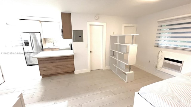 427 Santander Ave Unit 202, Coral Gables, FL 33134 - kitchen featuring stainless steel refrigerator with ice dispenser, electric panel, light countertops, and a peninsula