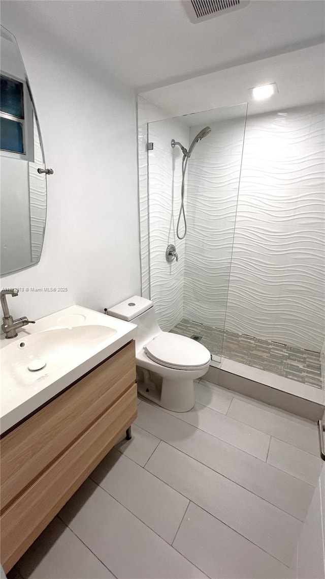 427 Santander Ave Unit 202, Coral Gables, FL 33134 - bathroom featuring a tile shower, vanity, and tile patterned flooring