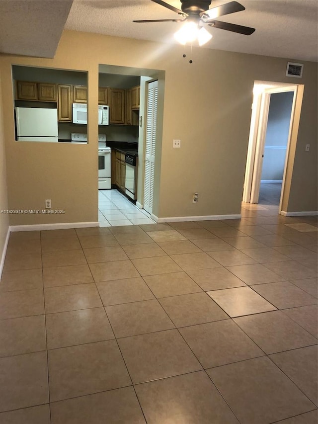 10740 Royal Palm Blvd, Coral Springs, FL 33065 - unfurnished room with light tile patterned floors, a ceiling fan, and a textured ceiling