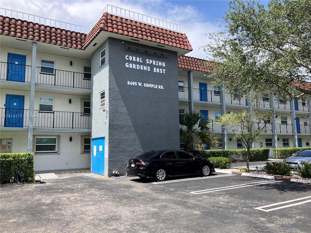 8605 W Sample Rd Unit 101, Coral Springs, FL 33065 - view of building exterior featuring uncovered parking