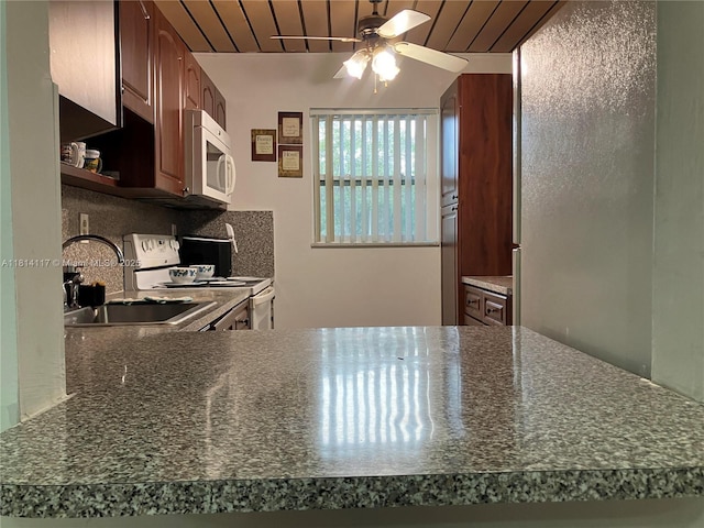 8605 W Sample Rd Unit 101, Coral Springs, FL 33065 - kitchen with white appliances, ceiling fan, dark countertops, wooden ceiling, and tasteful backsplash