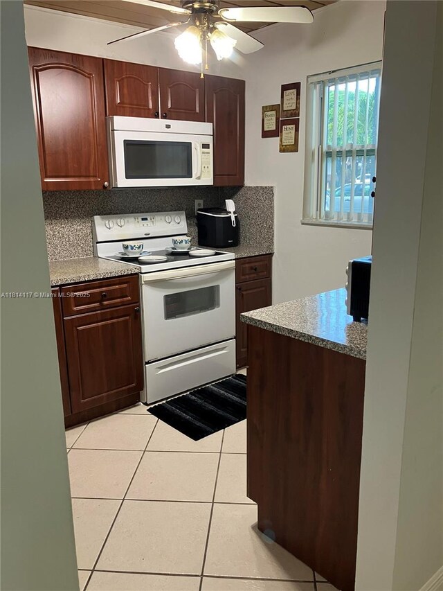 8605 W Sample Rd Unit 101, Coral Springs, FL 33065 - kitchen with white appliances, a ceiling fan, light tile patterned floors, light countertops, and decorative backsplash