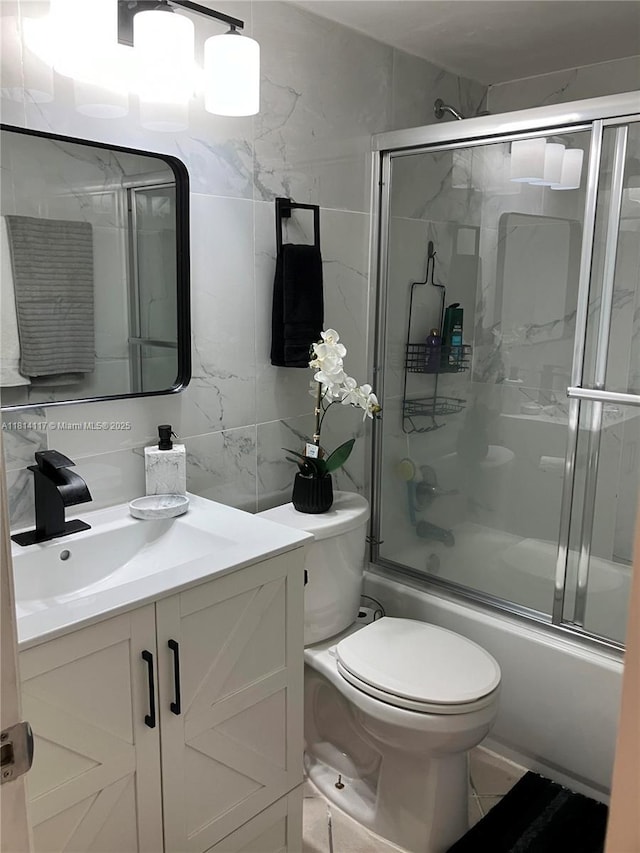 8605 W Sample Rd Unit 101, Coral Springs, FL 33065 - bathroom featuring vanity, shower / bath combination with glass door, tile walls, and tasteful backsplash