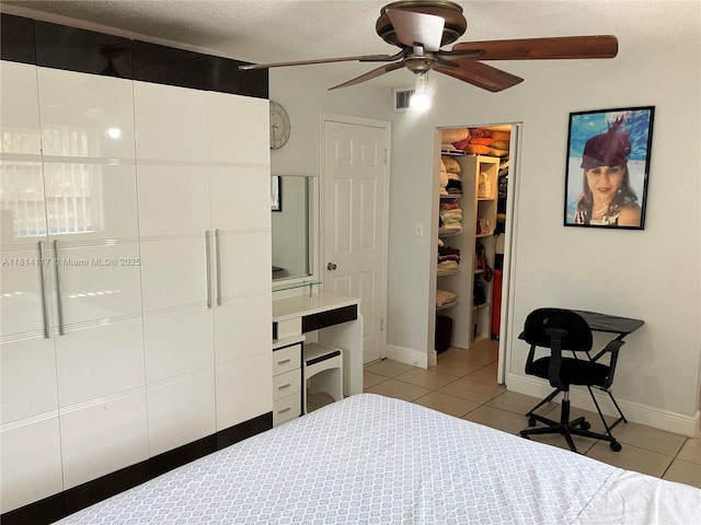 8605 W Sample Rd Unit 101, Coral Springs, FL 33065 - bedroom with light tile patterned flooring, a walk in closet, a closet, a textured ceiling, and an office area