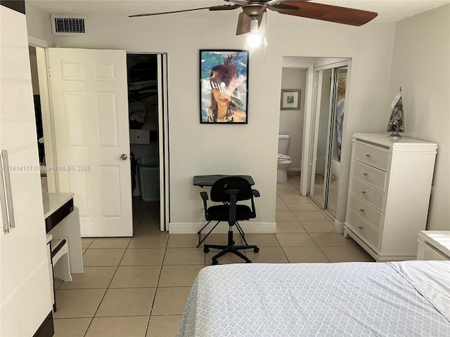 8605 W Sample Rd Unit 101, Coral Springs, FL 33065 - bedroom with light tile patterned floors, ensuite bath, and ceiling fan