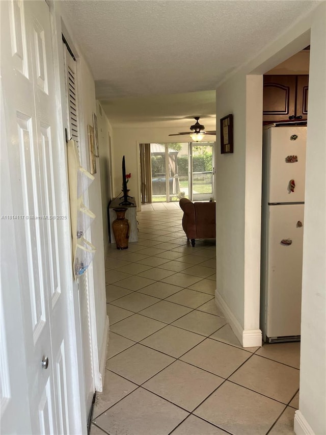 8605 W Sample Rd Unit 101, Coral Springs, FL 33065 - hall featuring light tile patterned flooring and a textured ceiling