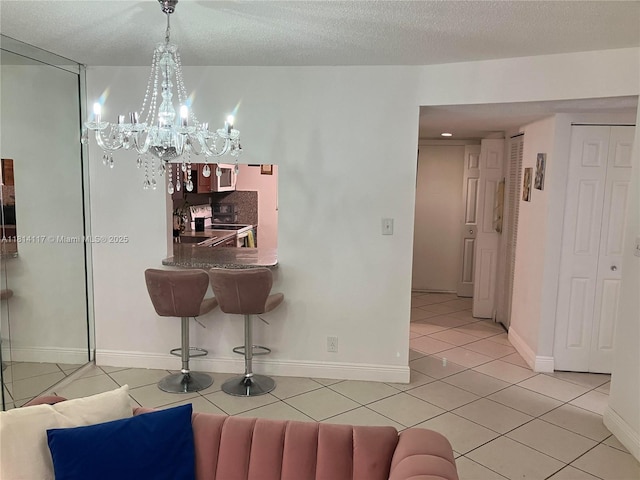 8605 W Sample Rd Unit 101, Coral Springs, FL 33065 - dining space featuring a chandelier, light tile patterned floors, and a textured ceiling
