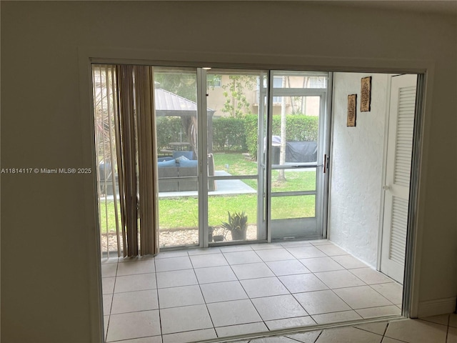 8605 W Sample Rd Unit 101, Coral Springs, FL 33065 - doorway to outside featuring light tile patterned flooring and a textured wall