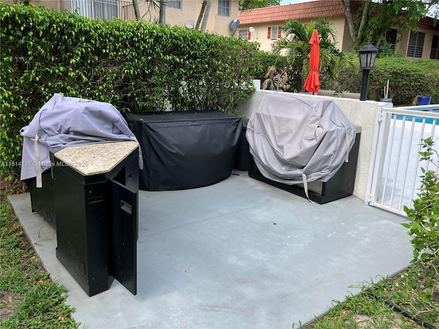 8605 W Sample Rd Unit 101, Coral Springs, FL 33065 - view of patio featuring a grill and a pool