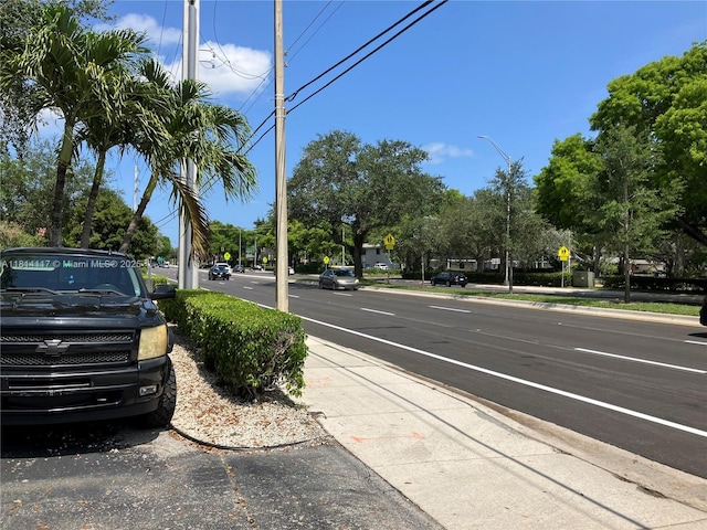 8605 W Sample Rd Unit 101, Coral Springs, FL 33065 - view of asphalt street featuring traffic signs, sidewalks, curbs, and street lights