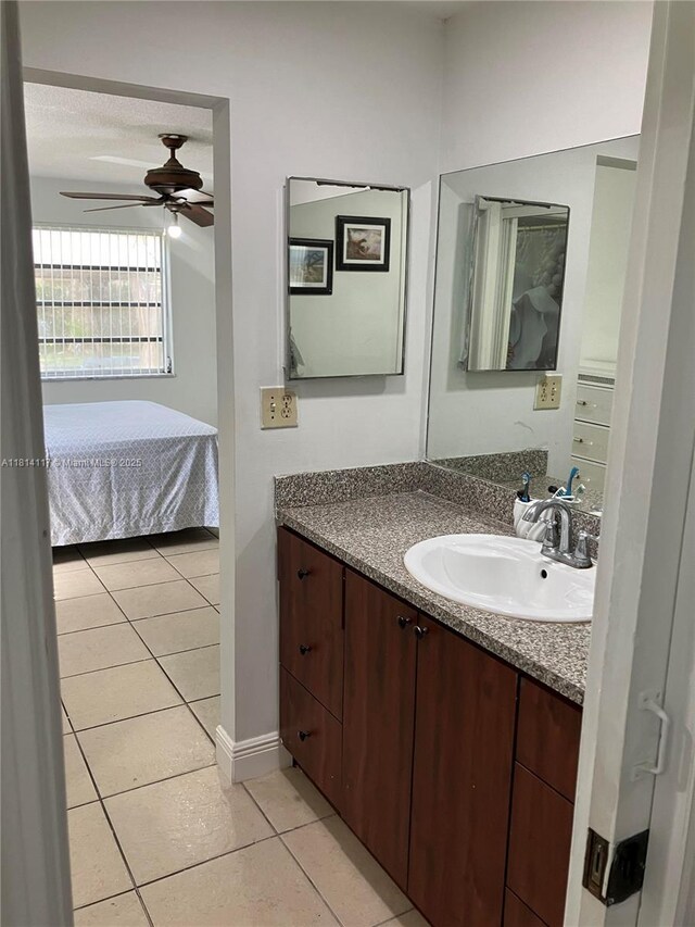 8605 W Sample Rd Unit 101, Coral Springs, FL 33065 - ensuite bathroom with vanity, tile patterned floors, and a ceiling fan