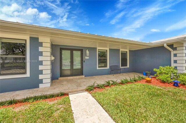 8861 SW 85th St, Miami, FL 33173 - property entrance featuring a lawn and stucco siding
