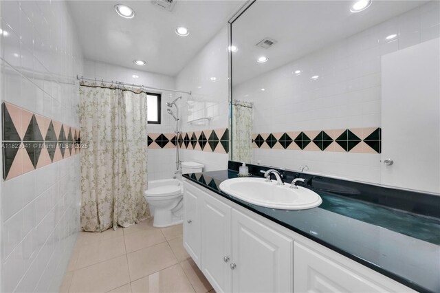 8861 SW 85th St, Miami, FL 33173 - bathroom with tile walls, vanity, tile patterned floors, recessed lighting, and shower / tub combo