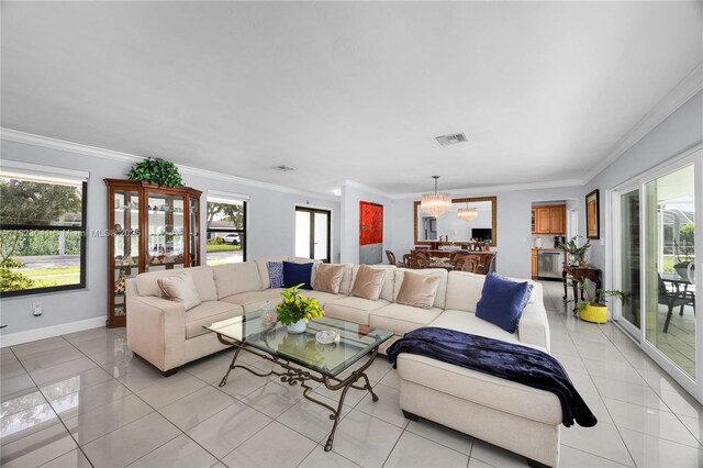 8861 SW 85th St, Miami, FL 33173 - living room with healthy amount of natural light, light tile patterned floors, crown molding, and a chandelier