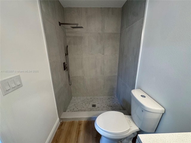 737 SE Brookedge Ave, Port St Lucie, FL 34983 - bathroom featuring a tile shower, wood finished floors, and vanity