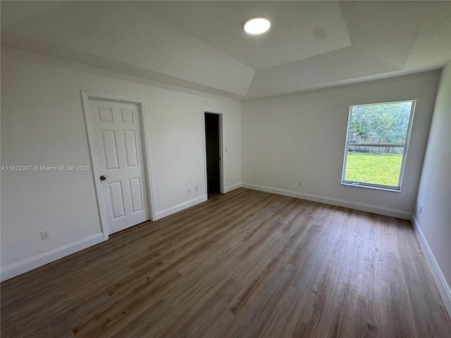 737 SE Brookedge Ave, Port St Lucie, FL 34983 - spare room with dark wood finished floors and a tray ceiling
