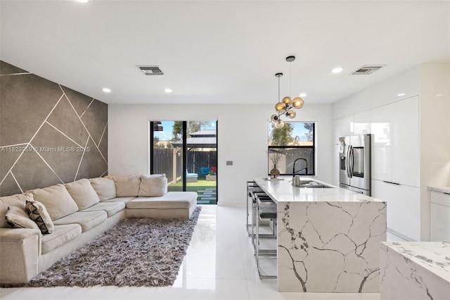 8780 NW 116th Path, Doral, FL 33178 - living room with recessed lighting, light tile patterned flooring, and tile walls