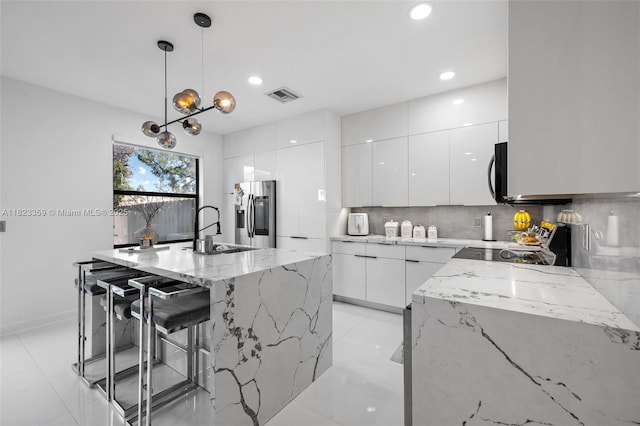 8780 NW 116th Path, Doral, FL 33178 - kitchen featuring appliances with stainless steel finishes, modern cabinets, white cabinetry, decorative backsplash, and recessed lighting