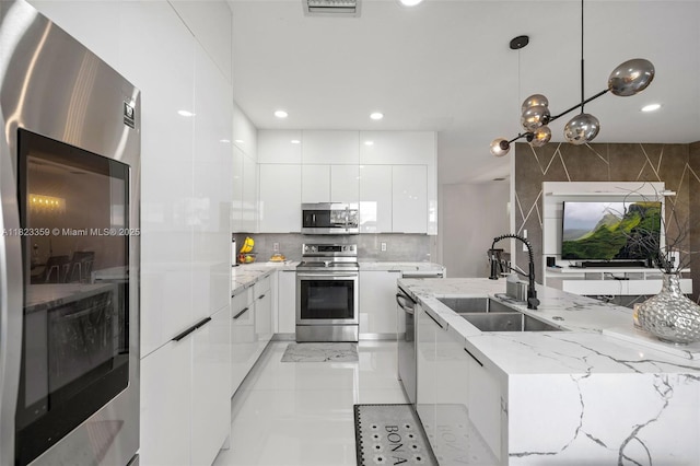8780 NW 116th Path, Doral, FL 33178 - kitchen featuring modern cabinets, appliances with stainless steel finishes, white cabinetry, recessed lighting, and decorative light fixtures