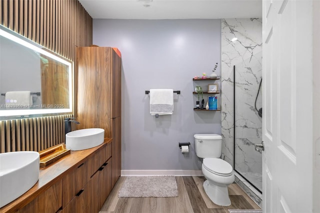 8780 NW 116th Path, Doral, FL 33178 - full bathroom with double vanity, wood finished floors, and a marble finish shower