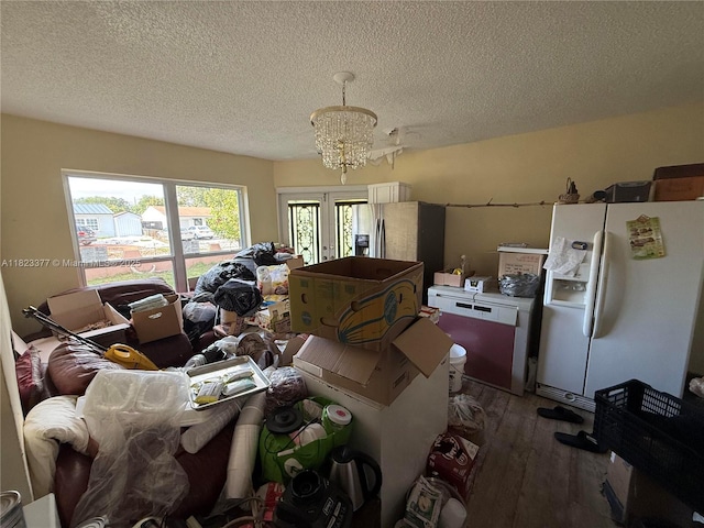 7080 Hope St, Hollywood, FL 33024 - living room with hardwood / wood-style flooring, a textured ceiling, and a chandelier