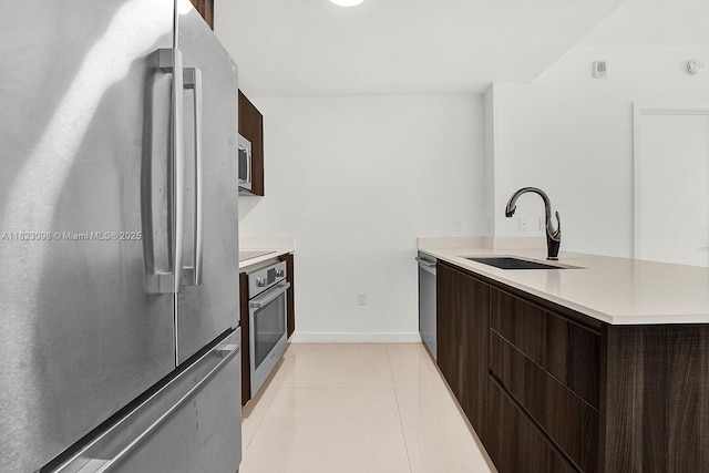 488 NE 18th St Unit 3105, Miami, FL 33132 - kitchen featuring stainless steel appliances, modern cabinets, dark brown cabinetry, and light countertops