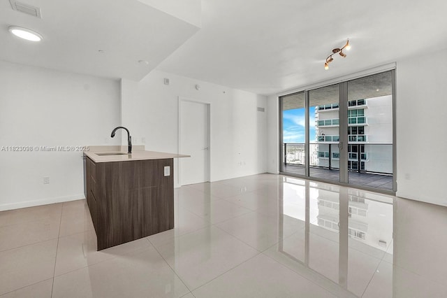 488 NE 18th St Unit 3105, Miami, FL 33132 - kitchen featuring a wall of windows, tile patterned floors, a center island with sink, open floor plan, and modern cabinets