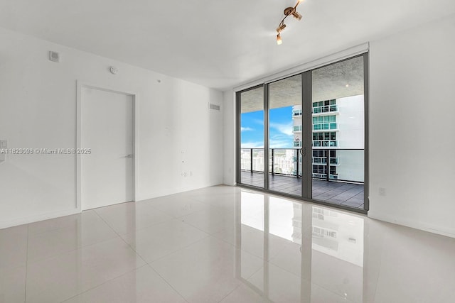 488 NE 18th St Unit 3105, Miami, FL 33132 - tiled empty room with floor to ceiling windows and baseboards