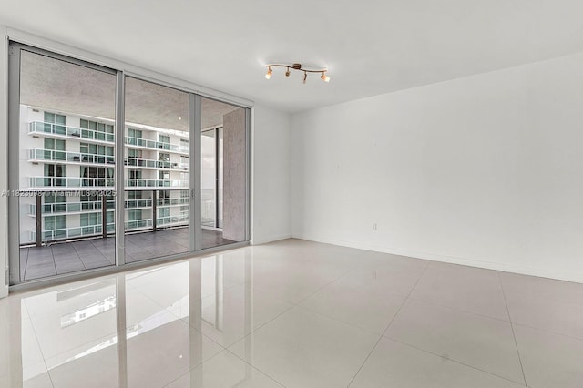 488 NE 18th St Unit 3105, Miami, FL 33132 - unfurnished room featuring a wall of windows and tile patterned floors