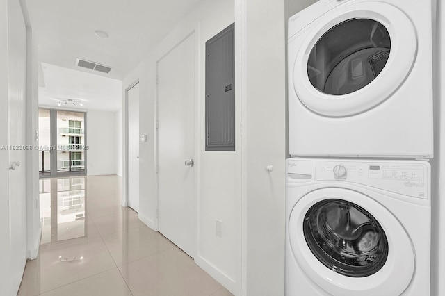 488 NE 18th St Unit 3105, Miami, FL 33132 - laundry room featuring stacked washer / dryer, electric panel, and light tile patterned floors