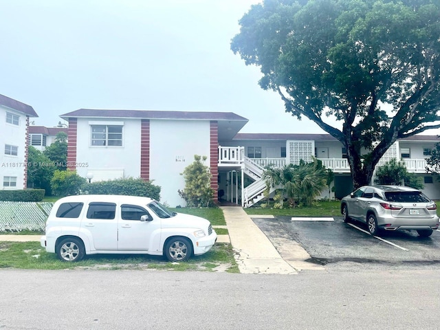 1311 NW 43rd Ave Unit 102, Lauderhill, FL 33313 - multi unit property with uncovered parking, stairway, and stucco siding