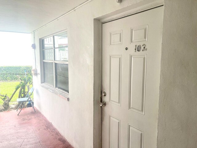 1311 NW 43rd Ave Unit 102, Lauderhill, FL 33313 - view of exterior entry featuring stucco siding