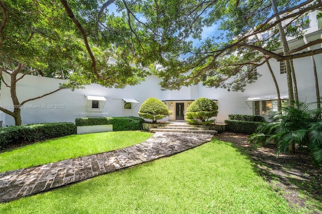 1839 W 24th St, Miami Beach, FL 33140 - view of front of home with a front yard and stucco siding