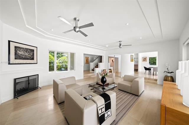 1839 W 24th St, Miami Beach, FL 33140 - living room featuring a raised ceiling, ceiling fan, stairway, a glass covered fireplace, and recessed lighting