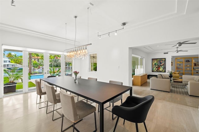 1839 W 24th St, Miami Beach, FL 33140 - dining area with french doors, a ceiling fan, a tray ceiling, and a chandelier