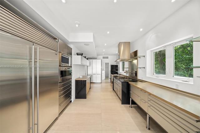 1839 W 24th St, Miami Beach, FL 33140 - kitchen with built in appliances, island range hood, modern cabinets, recessed lighting, and light countertops