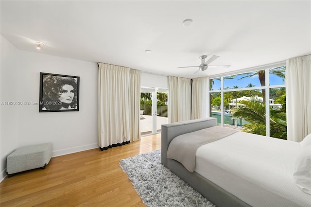 1839 W 24th St, Miami Beach, FL 33140 - bedroom with access to outside, multiple windows, light wood-type flooring, and a ceiling fan