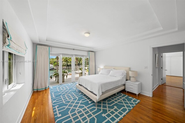 1839 W 24th St, Miami Beach, FL 33140 - bedroom with a raised ceiling, access to exterior, and wood finished floors