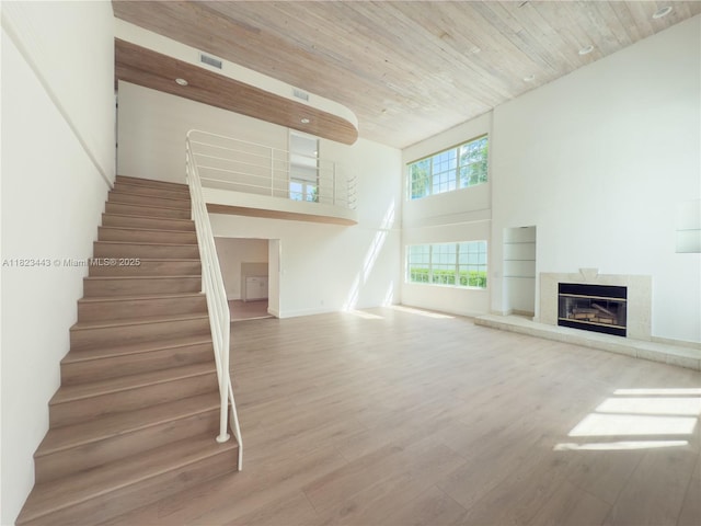 8390 SW 94th St, Miami, FL 33156 - unfurnished living room with a fireplace, stairs, wood finished floors, a high ceiling, and wooden ceiling